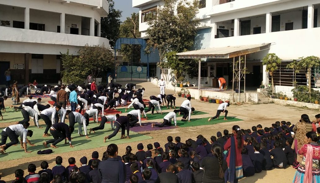 students performing yoga asana at yoga workshop